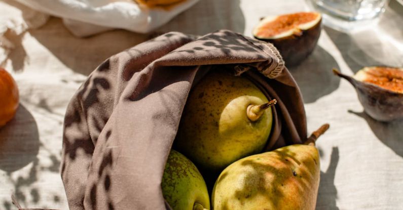 Eco-Friendly Brands - Bags with Fresh Fruits and a Glass of Water Standing in Sunlight