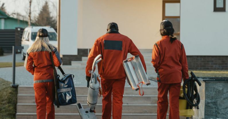 Vacuum Cleaners - Back View of Workers Walking towards a House