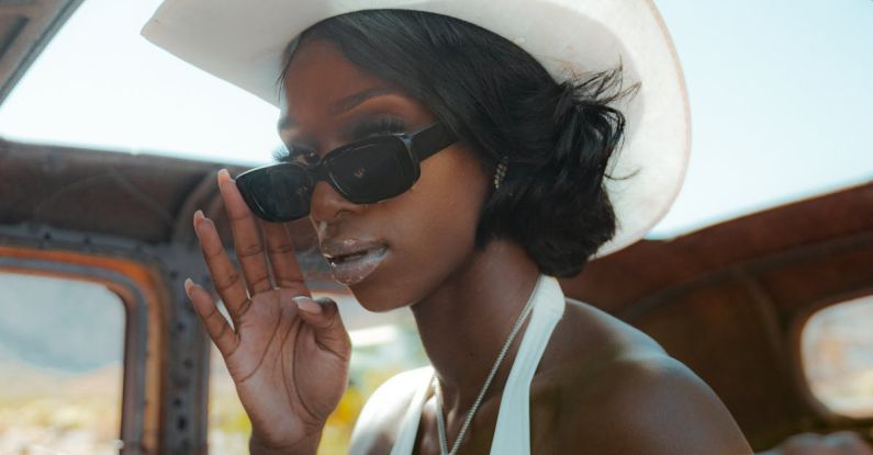 Window Shades - Confident trendy black woman in retro car