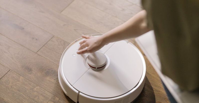 Robot Vacuums - Person in Brown Shirt Holding White Round Plate