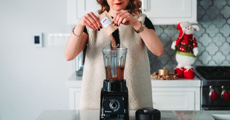 Blender - Womna Pouring Powder on the Blender