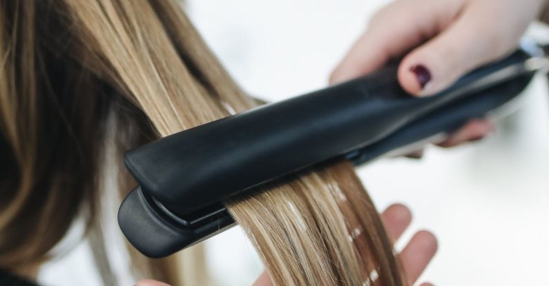 Straighteners - Person Ironing a Woman's Hair