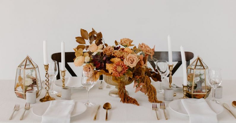 Knife Sets - Wooden chair placed near banquet table with elegant dishware decorated with candles and floral composition against white wall