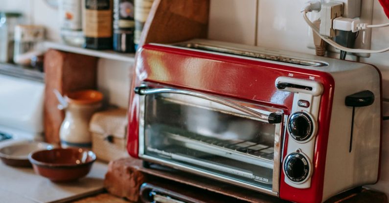 Toasters - Part of kitchen with paper towels and toaster oven standing on old shabby table