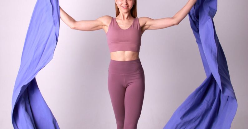 Hammocks - A Smiling Woman in Purple Activewear Holding Two Purple Hammocks