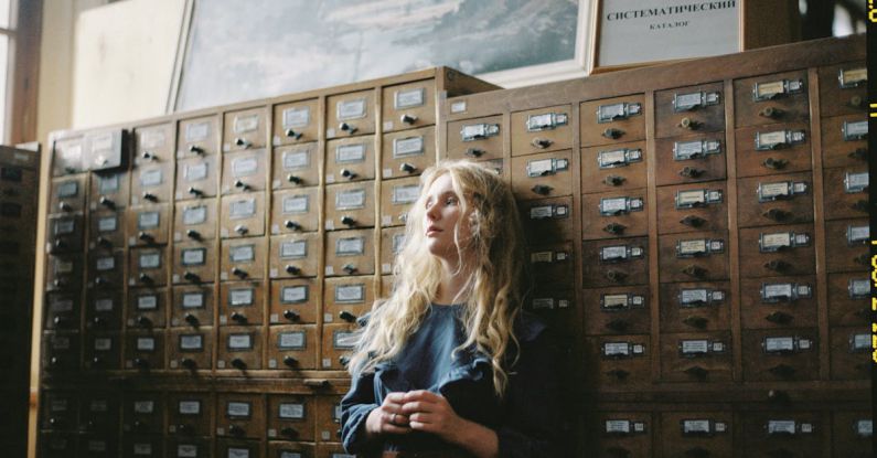 Filing Cabinets - Woman in Blue Long Sleeve Dress Standing Beside Brown Wooden Cabinet