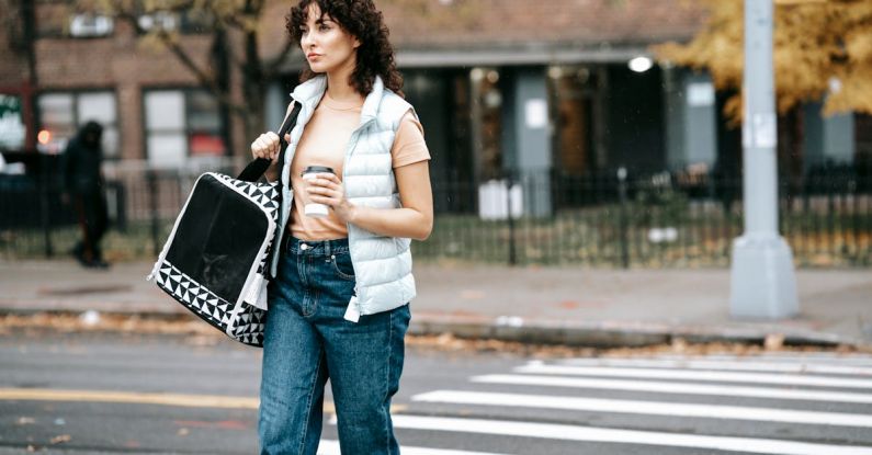 Pet Carriers - Woman with pet carrier and coffee to go crossing road